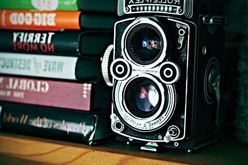 camera vintage camera beside stack of books santa barbara